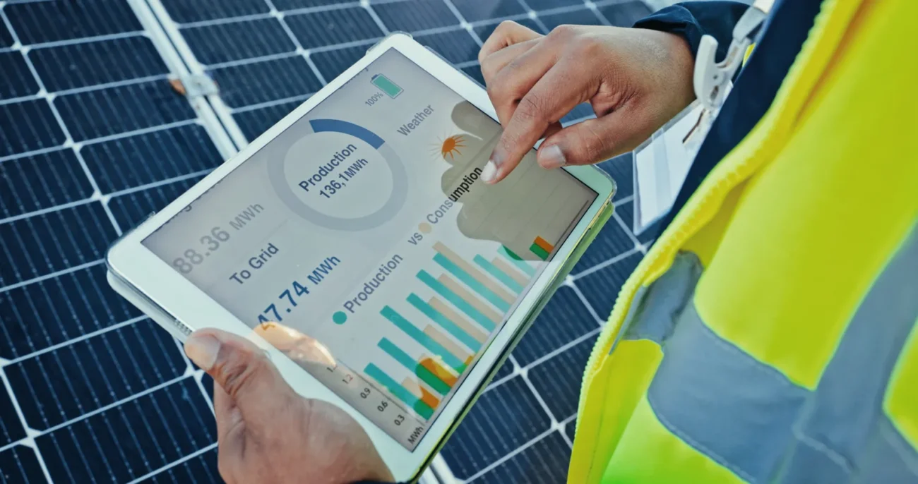 Close-up of a tablet displaying solar energy production data from a commercial string inverter.