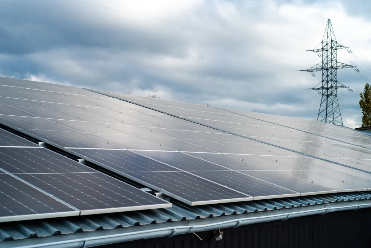 Rooftop solar panels with power grid infrastructure, paired with high voltage hybrid inverter technology.