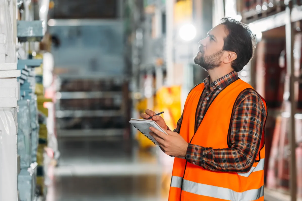 Warehouse specialist conducting inventory checks to support wholesale off-grid solar inverter procurement decisions.