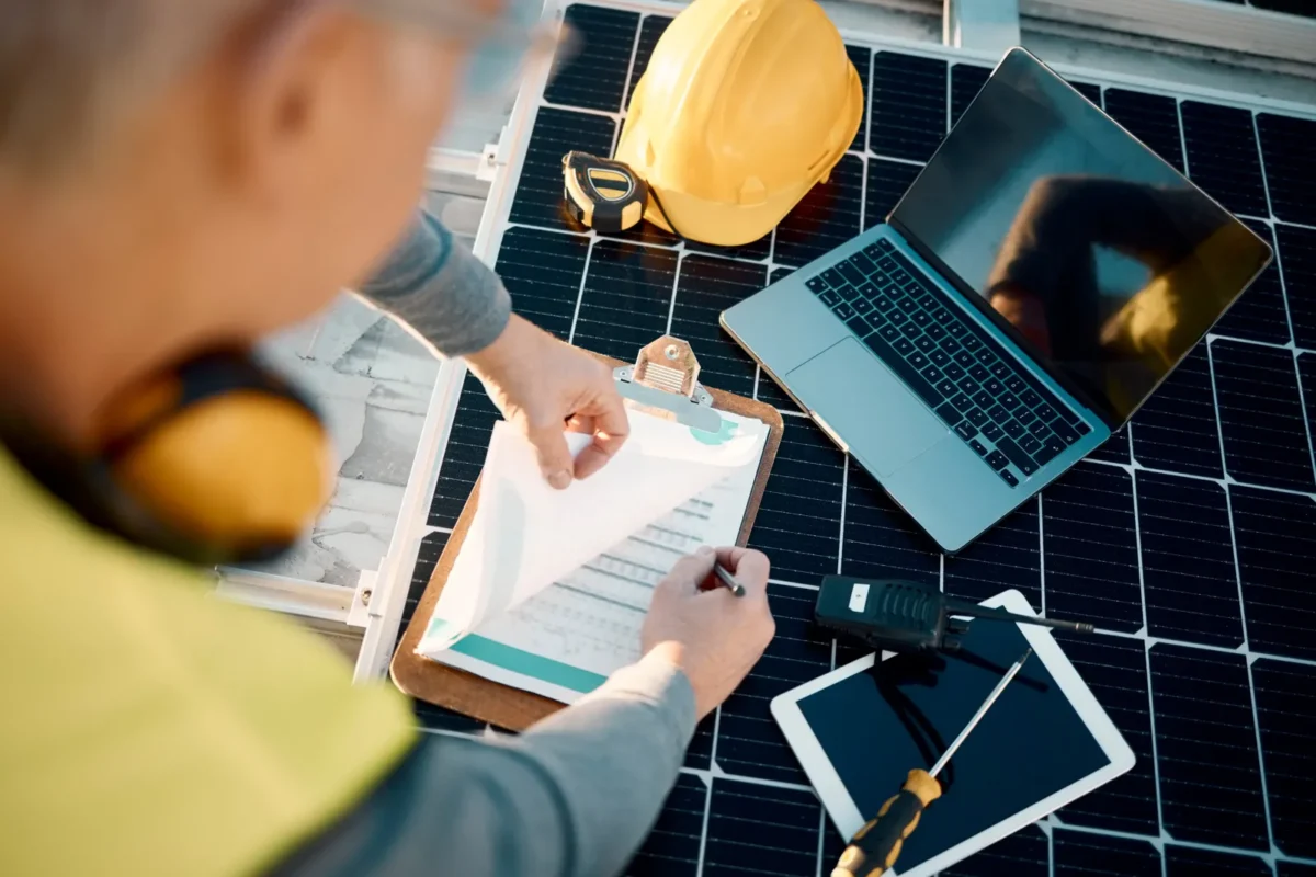 An engineer reviews installation plans for a residential PV inverter bulk supply project.