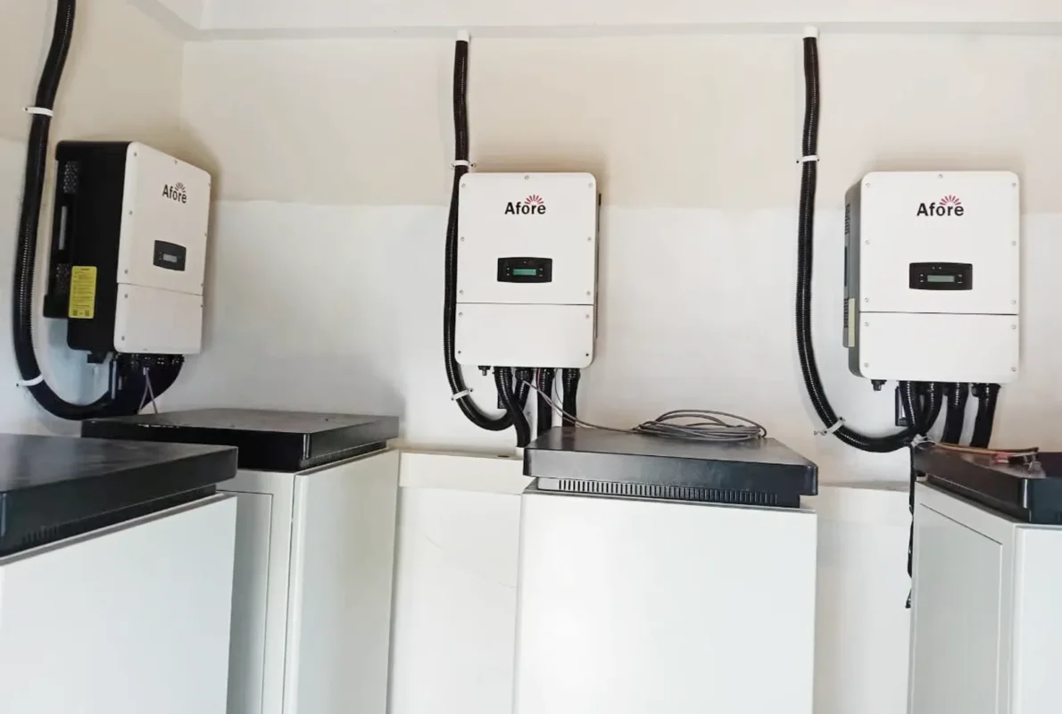 Multiple solar inverters mounted on a wall, ready for replacement or maintenance service