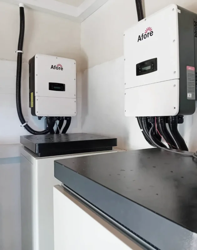 Two Afore inverters wall-mounted next to black battery units in a commercial installation.