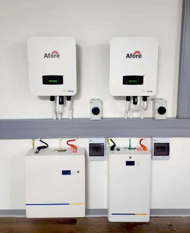 Residential and commercial dual solar inverter installation with battery storage, showcasing compact equipment layout for efficiency testing and side-by-side performance comparison.